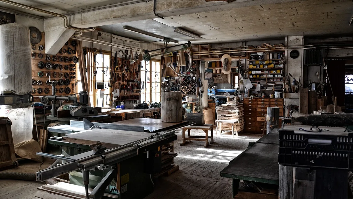A carpenter&rsquo;s workshop with hand tools racked along the wall